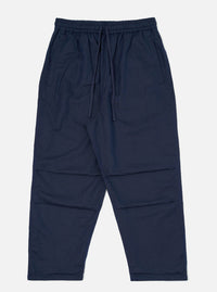 A pair of Navy Linen Cotton Shirting Parachute Pants is shown laid flat against a solid white background. The trousers feature a loose, relaxed fit with an elasticated waistband and a visible drawstring. Key details include angled front hand pockets and pronounced darting at the knees to create a structured, curved leg silhouette.