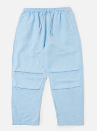 A pair of Pale Blue Linen Cotton Shirting Parachute Pants is displayed flat against a plain white background. The trousers feature a relaxed, straight-leg cut with a drawstring waistband and side slip pockets.