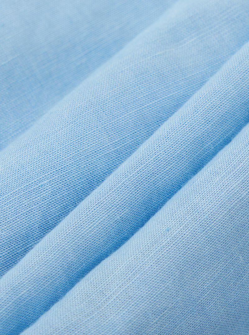 A detailed, close-up fabric swatch of the Pale Blue Linen Cotton Shirting Parachute Pant. The image highlights the fine weave and soft, light blue texture of the linen-cotton blend material.