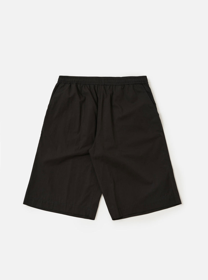 A pair of Black Broadcloth Vacation Shorts is displayed flat against a plain white background. The shorts feature an elasticated waistband with a tonal drawstring and a relaxed, wide-leg fit.
