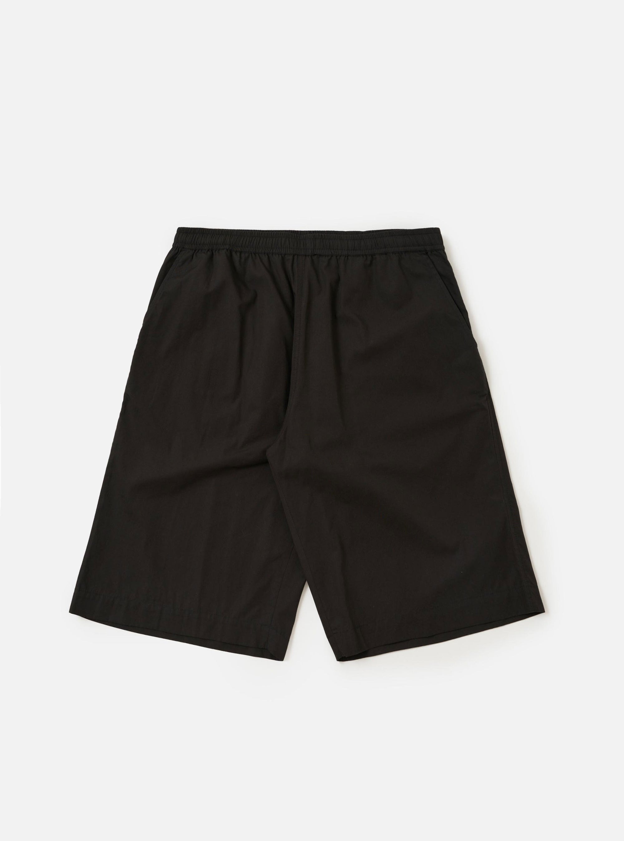 A pair of Black Broadcloth Vacation Shorts is displayed flat against a plain white background. The shorts feature an elasticated waistband with a tonal drawstring and a relaxed, wide-leg fit.