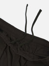 A pair of black broadcloth vacation shorts is displayed flat against a plain white background. The shorts feature a relaxed fit, an elasticated waistband with a visible drawstring, and a smooth, matte fabric texture.