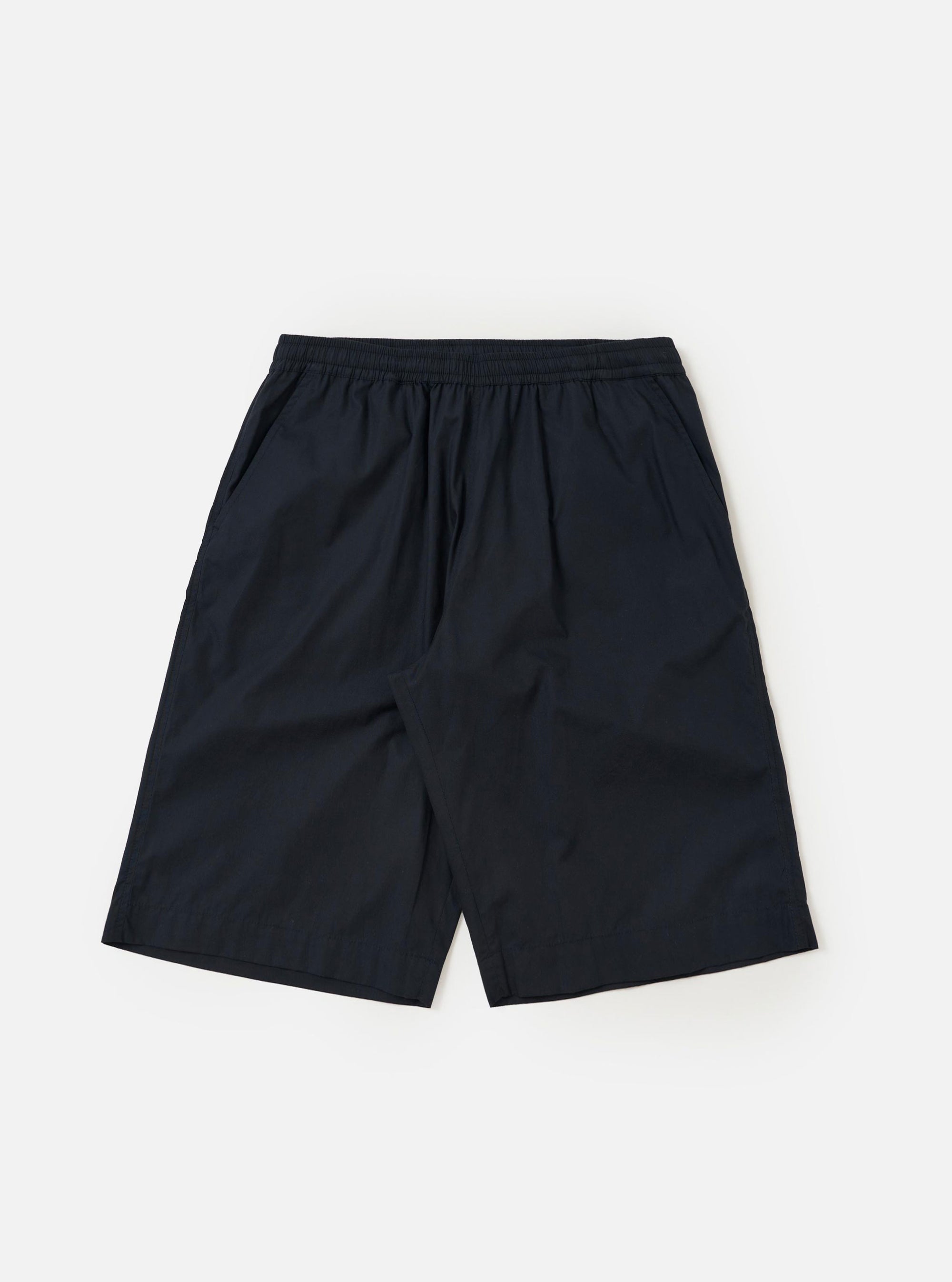 A pair of Navy Broadcloth Vacation Shorts is shown laid flat against a plain white background. The shorts feature a deep navy blue cotton fabric, an elasticated waistband with a drawstring, and a relaxed, straight-leg silhouette.
