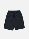 The Navy Broadcloth Vacation Short is shown from a rear angle, laid flat against a plain white background. The image highlights the lightweight navy blue cotton fabric, an elasticated waistband, and a single rear patch pocket on the right side.