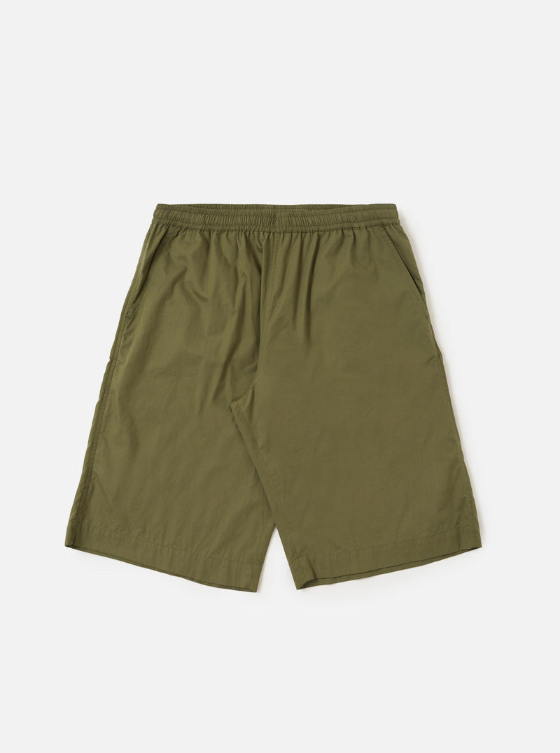 A pair of Olive Broadcloth Vacation Shorts is shown laid flat against a plain white background. The shorts feature a relaxed, wide-leg cut with an elasticated waistband and a tonal olive green drawstring. Key details include two side slip pockets and a clean, lightweight cotton broadcloth texture.
