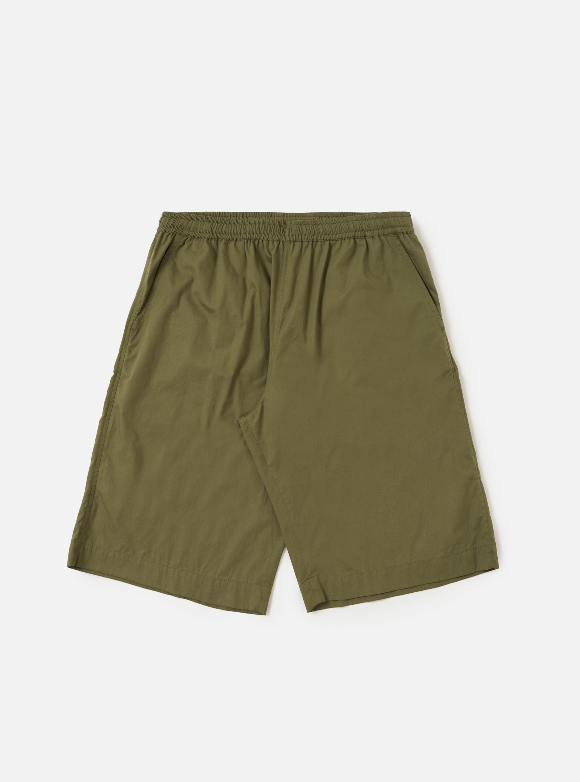A pair of Olive Broadcloth Vacation Shorts is shown laid flat against a plain white background. The shorts feature a relaxed, wide-leg cut with an elasticated waistband and a tonal olive green drawstring. Key details include two side slip pockets and a clean, lightweight cotton broadcloth texture.