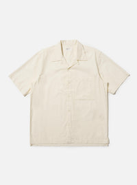 The Ecru Broadcloth Camp Shirt is shown laid flat against a solid white background. The shirt features a relaxed fit, short sleeves, and a classic one-piece camp collar. A single large square chest pocket is visible on the left side, and the front has a tonal button closure.