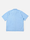 A Pale Blue Broadcloth Camp Shirt is shown from the back, laid flat against a plain white background. The image prominently features the back yoke with small pleats and a straight, even hem.