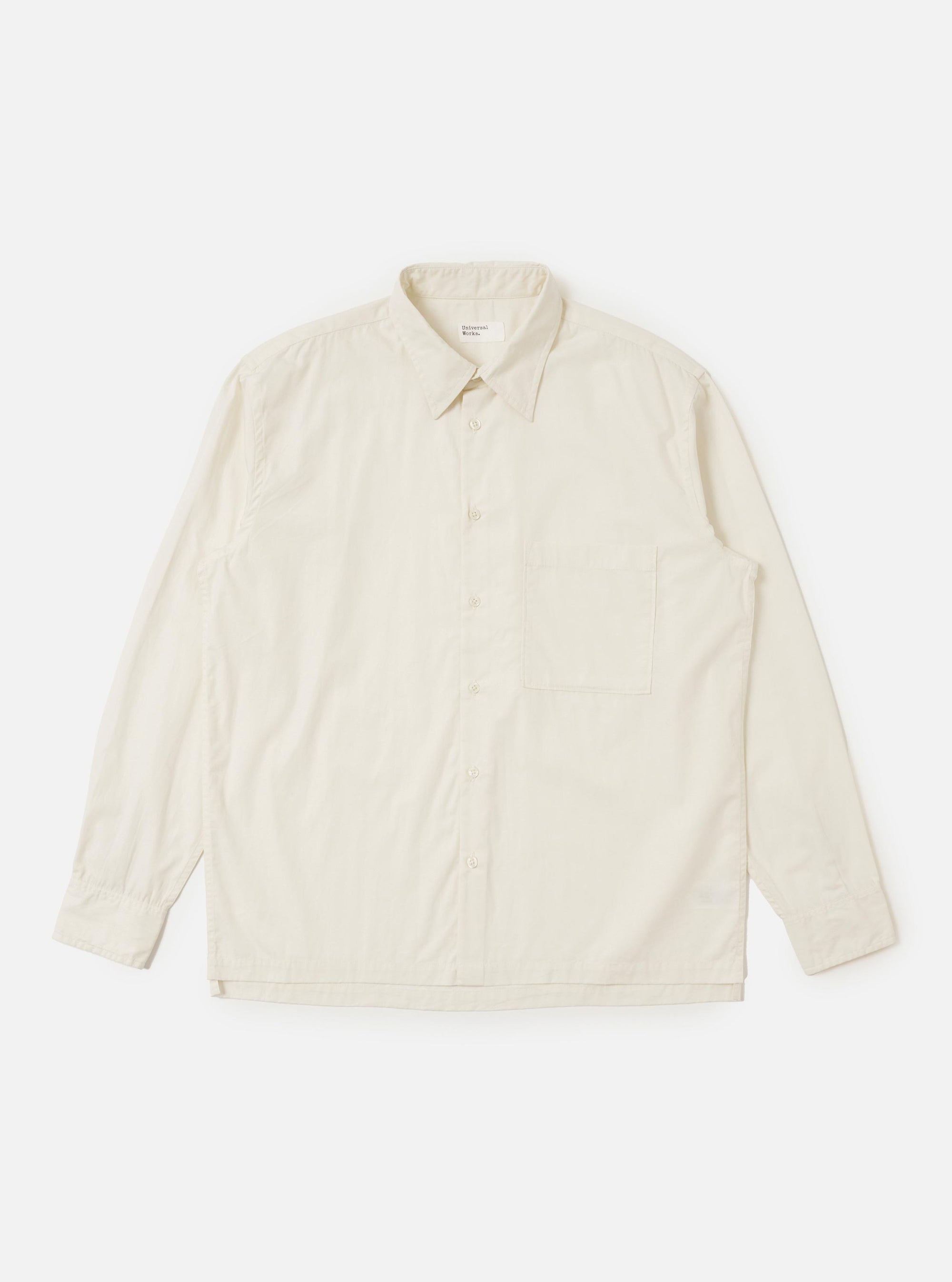 The Ecru Broadcloth Lucky Shirt is displayed laid flat against a plain white background. The shirt features a relaxed fit with a straight hem, a standard pointed collar, and a single large square pocket on the left chest. The short sleeves and full button-down front are clearly visible.