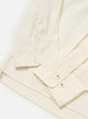 The Ecru Broadcloth Lucky Shirt is shown from a rear perspective, laid flat against a solid white background. The image highlights the horizontal back yoke and the clean, simple construction of the short-sleeved garment.