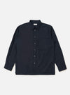 The Navy Broadcloth Lucky Shirt is shown laid flat against a solid white background. The garment is a short-sleeved button-up shirt featuring a classic pointed collar, a full button-down front, and two large patch pockets on the chest. The navy blue broadcloth fabric appears smooth and uniform in color.