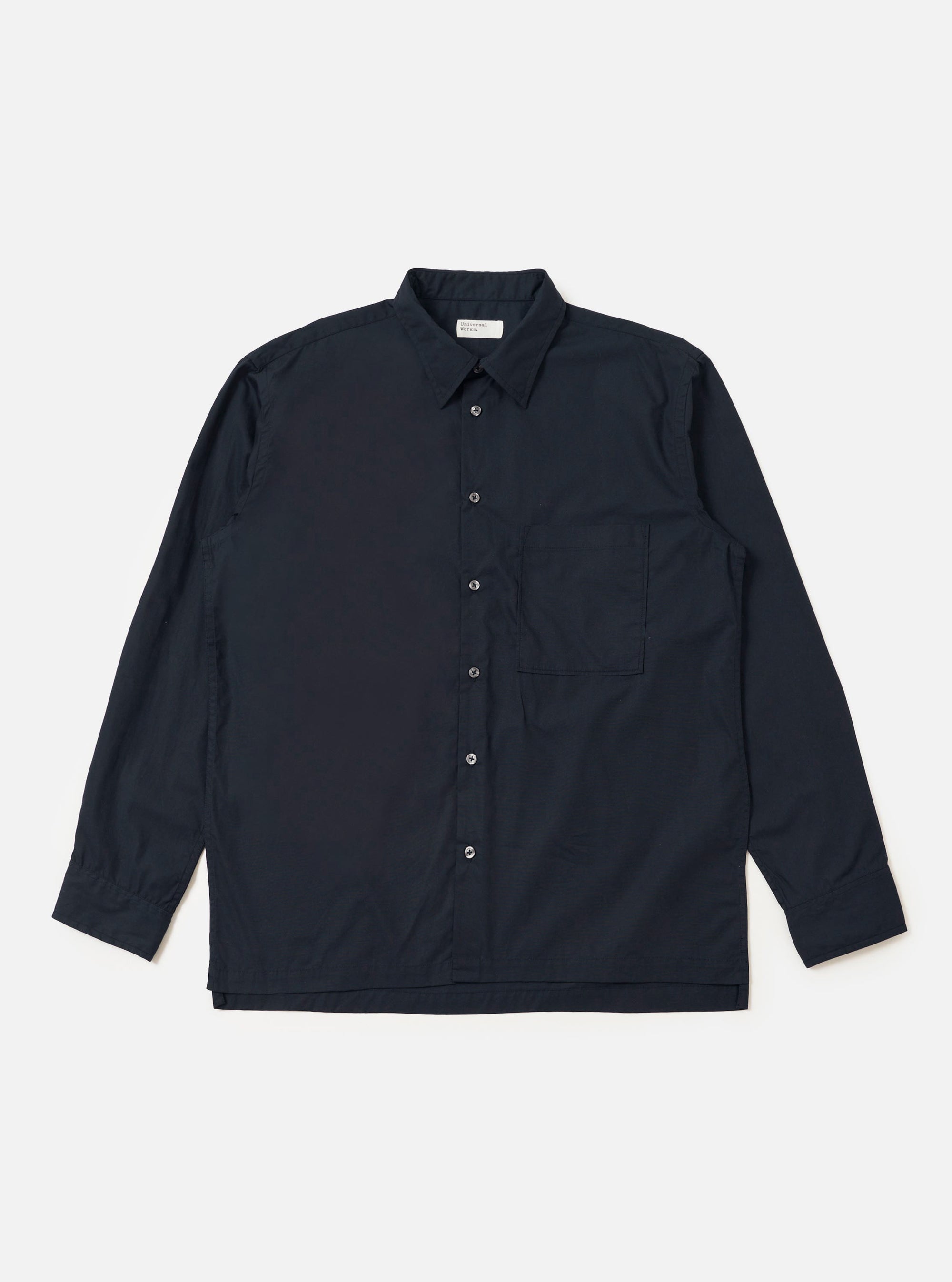 The Navy Broadcloth Lucky Shirt is shown laid flat against a solid white background. The garment is a short-sleeved button-up shirt featuring a classic pointed collar, a full button-down front, and two large patch pockets on the chest. The navy blue broadcloth fabric appears smooth and uniform in color.