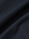 A close-up fabric swatch of the Navy Broadcloth Lucky Shirt shows the smooth, tightly woven texture of the navy blue cotton material. The image focuses on the uniform color and fine grain of the broadcloth fabric.