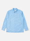 A Pale Blue Broadcloth Lucky Shirt is shown laid flat against a plain white background. The garment features a light blue color, a classic two-piece collar, a full button-down front, and a single large square chest pocket on the left side. The shirt has long sleeves and a straight hem.
