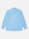The Pale Blue Broadcloth Lucky Shirt is shown from the back, laid flat against a plain white background. The image highlights the horizontal back yoke and a central box pleat, emphasizing the shirt's relaxed, loose fit.