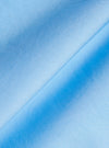 A detailed close-up fabric swatch of the Pale Blue Broadcloth Lucky Shirt shows the fine, smooth texture of the solid pale blue cotton broadcloth. The image focuses on the uniform, dense weave of the material.