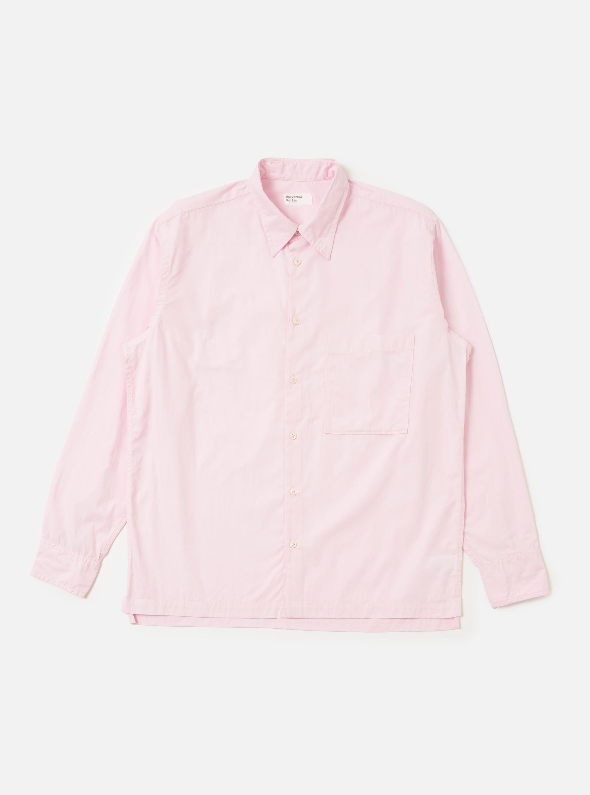 The Pale Pink Broadcloth Lucky Shirt is shown laid flat against a solid white background. The garment features a light pink color, a classic pointed collar, a full button-down front with tonal buttons, and a single chest pocket on the left side. The shirt has short sleeves and a straight hem.