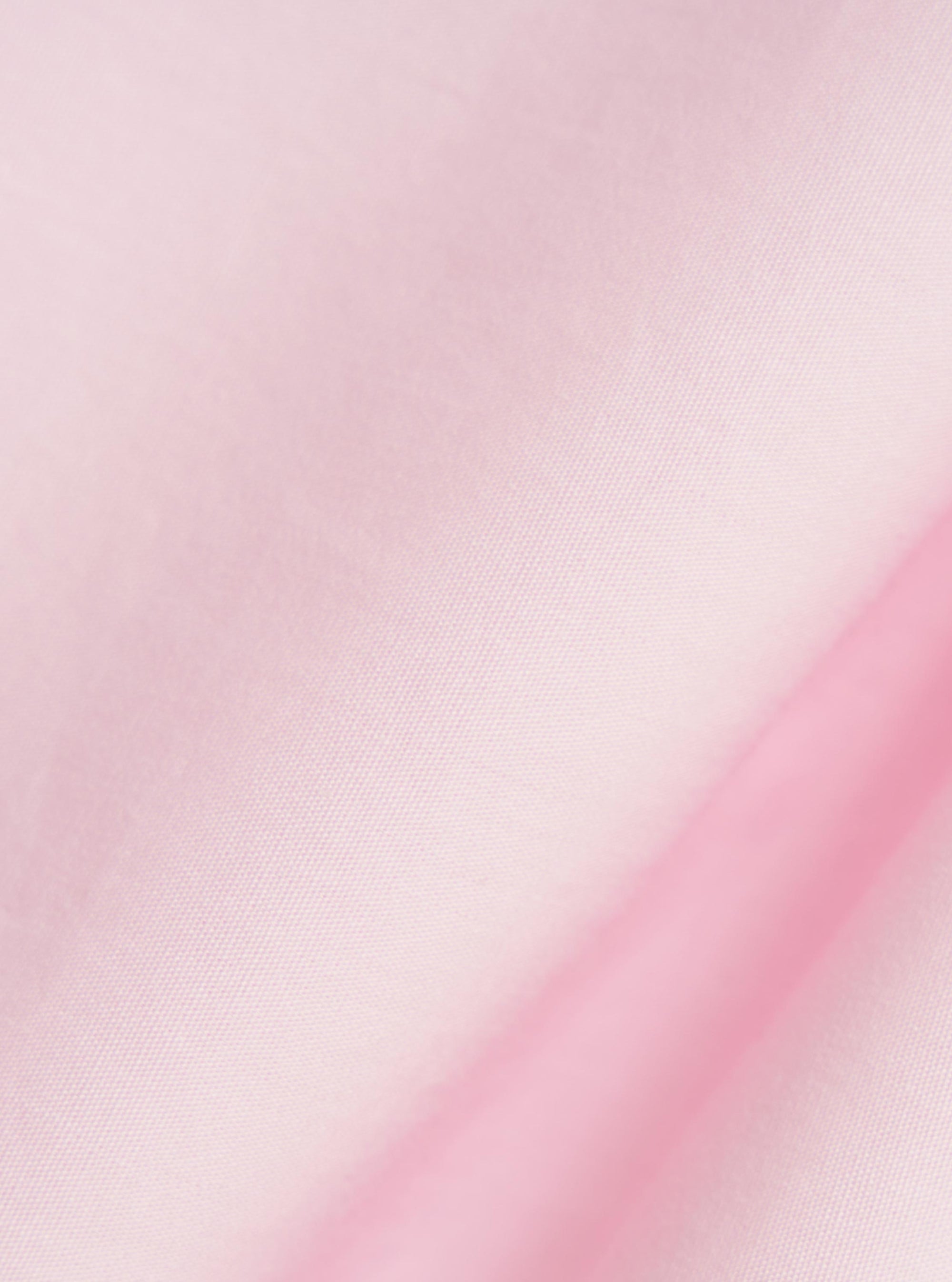 A close-up fabric swatch of the Pale Pink Broadcloth Lucky Shirt highlights the smooth, fine weave and light pink color of the material.