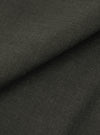 A close-up, square fabric swatch displays the detailed texture and color of the Olive Marl Tropical Suiting Vacation Short. The fabric features a fine, woven marl pattern in shades of olive green.