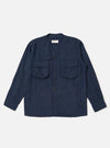 The Navy Linen Cotton Shirting Parachute Shirt is shown laid flat against a solid white background. The garment features a collarless V-neckline with a cardigan-style button front, two large 3D bellows pockets on the chest with buttoned flaps, and two vertical welt hand pockets near the hem. The shirt has long sleeves with adjustable button cuffs and a straight hem with an internal drawcord.