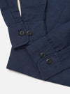 The Navy Linen Cotton Shirting Parachute Shirt is displayed flat against a plain white background. The image provides a close-up view of the back of the shirt, highlighting the straight hem, the back yoke, and the fine texture of the navy blue linen-cotton fabric.