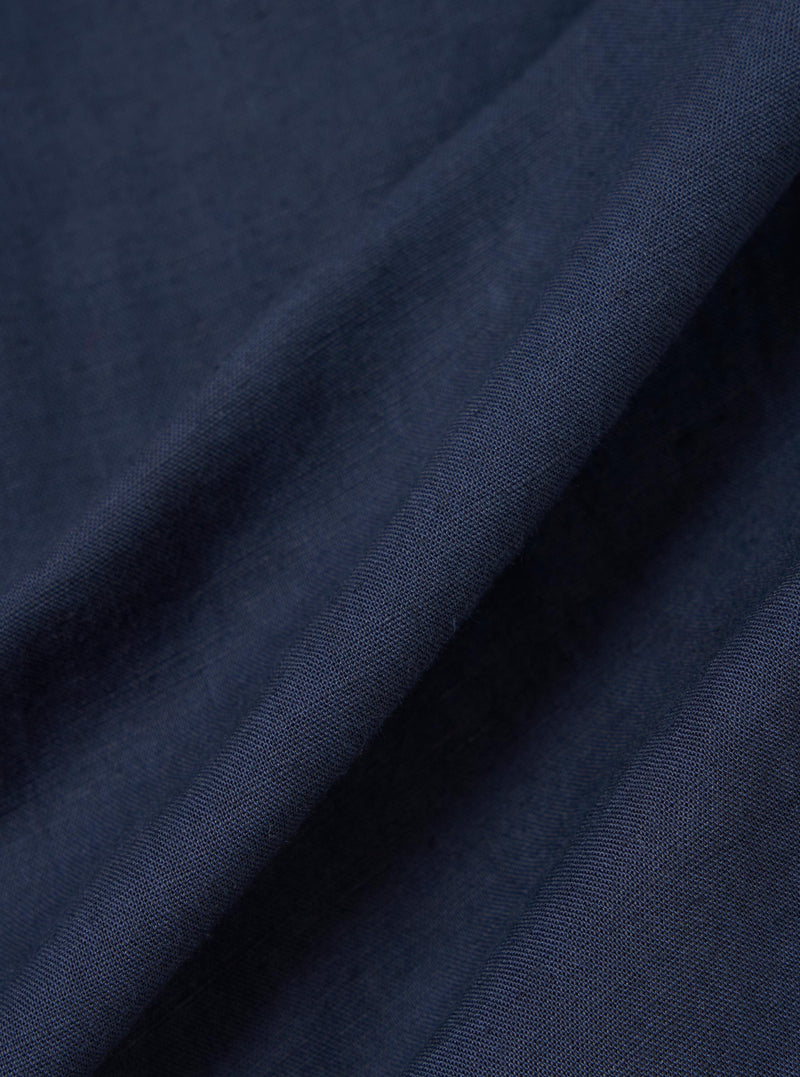 A close-up fabric swatch of the navy blue linen-cotton material used for the Navy Linen Cotton Shirting Parachute Shirt. The image highlights the fine, textured weave of the fabric.