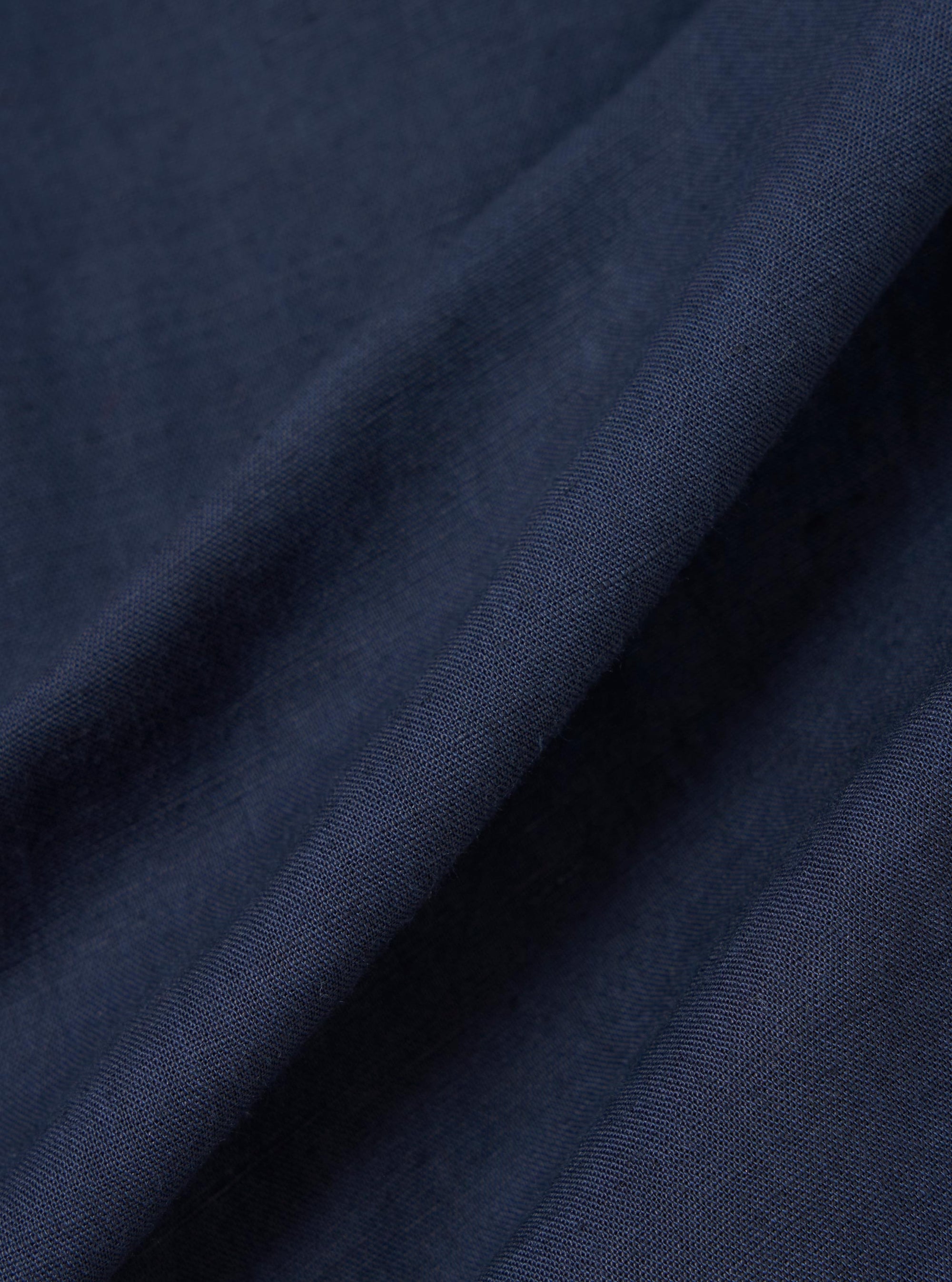 A close-up fabric swatch of the navy blue linen-cotton material used for the Navy Linen Cotton Shirting Parachute Shirt. The image highlights the fine, textured weave of the fabric.