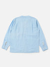 A model wears the Pale Blue Linen Cotton Shirting Parachute Shirt, shown from the front against a plain white background. The shirt features a relaxed fit, a classic collar, a full button-down front, and two large chest pockets. The model is standing with their hands by their sides, and the light blue fabric exhibits a subtle, natural linen texture.