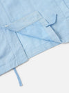 A Pale Blue Linen Cotton Shirting Parachute Shirt is displayed from a rear perspective against a plain white background. The image highlights the back yoke with two small pleats and the adjustable shirt cuffs.