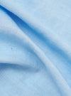 A close-up fabric swatch of the Pale Blue Linen Cotton Shirting Parachute Shirt. The image highlights the fine, textured weave of the material, which features a light blue color with a subtle, natural linen-cotton grain.