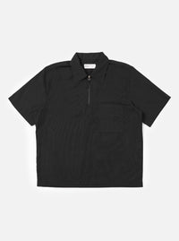 The Black Broadcloth Ewan Shirt is shown laid flat against a solid white background. This black pullover garment features a half-zip front, a classic pointed collar, and two large patch pockets on the chest.