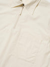 The Ecru Broadcloth Ewan Shirt is shown from the back, laid flat against a plain white background. The image highlights the shirt's long sleeves, straight hem, and horizontal back yoke. The garment is made from a smooth, off-white broadcloth material.
