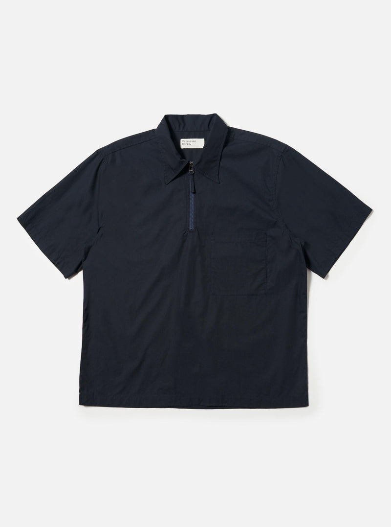The Navy Broadcloth Ewan Shirt is shown laid flat against a solid white background. The navy blue pullover shirt features a classic pointed collar, a short quarter-zip at the neckline, and long sleeves.