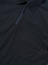 The Navy Broadcloth Ewan Shirt is shown from the back, displayed flat against a plain white background. The image highlights the short-sleeve silhouette, a straight hem with small side splits, and a horizontal yoke across the shoulders with a central box pleat.