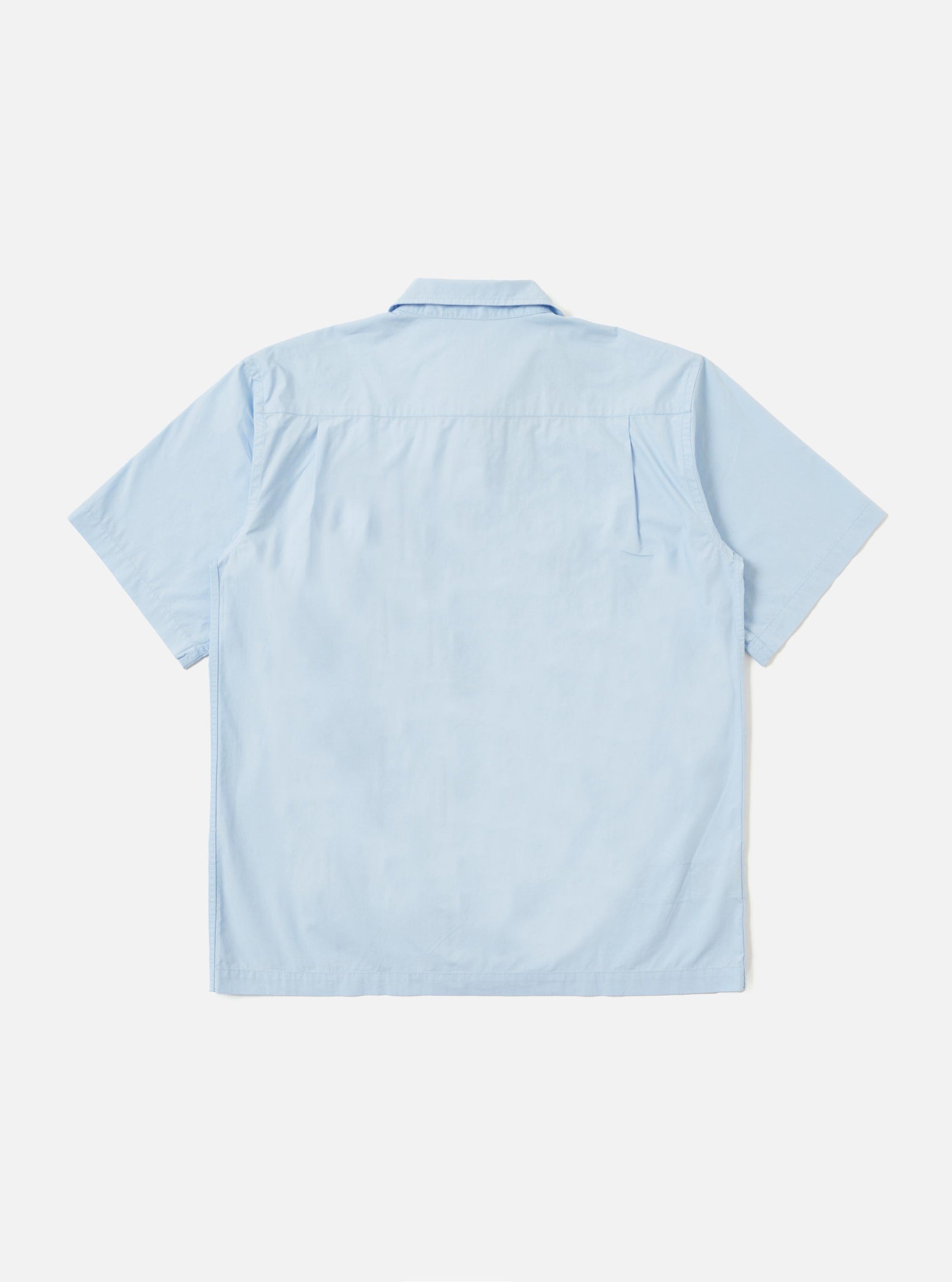 The Sky Blue Paper Touch Cotton S/S Fatigue Shirt is displayed flat against a plain white background. The shirt features a crisp sky blue cotton fabric, a classic pointed collar, a full button-down front, and two large utility-style patch pockets on the chest. The short sleeves and straight hem are clearly visible.