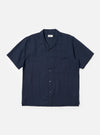 The Navy Linen Cotton Shirting Camp Shirt is displayed flat against a plain white background. This short-sleeve shirt features a camp collar, a single chest pocket on the left side, and a straight hem. The navy blue fabric has a subtle, textured appearance from the linen-cotton blend.