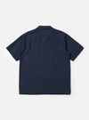 A male model is wearing the Navy Linen Cotton Shirting Camp Shirt against a plain white background. The shirt features short sleeves, a classic camp collar, and a button-down front. The model is shown from the chest up, highlighting the fabric texture and the relaxed fit of the collar. No mannequin is present in the image.