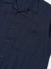 A model is wearing the Navy Linen Cotton Shirting Camp Shirt against a plain white background. The shirt features a relaxed fit, short sleeves, a classic camp collar, and a full-button front. The model is shown from the waist up, with the shirt worn untucked.