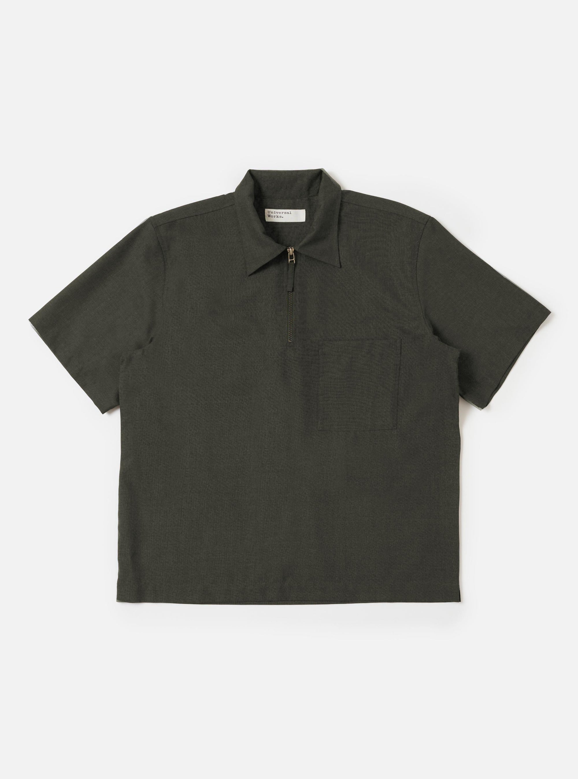 An Olive Marl Tropical Suiting Ewan Shirt is displayed flat against a plain white background. The garment is an olive green marl pullover shirt featuring a half-zip front closure, a classic pointed collar, and a single patch pocket on the chest.