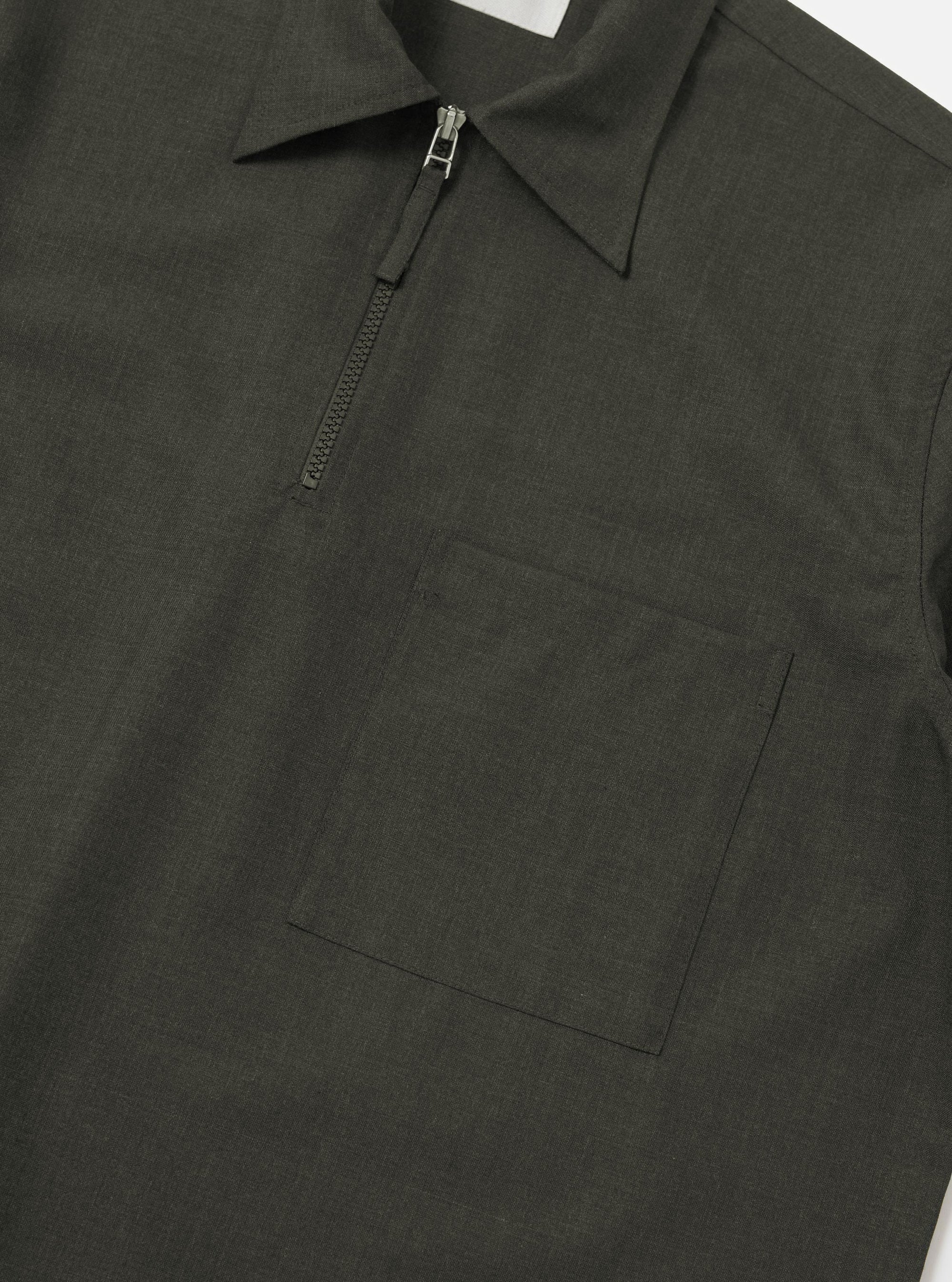 An Olive Marl Tropical Suiting Ewan Shirt is shown from the back, displayed flat against a plain white background. The image highlights the short sleeves, a straight hem, and a horizontal yoke across the shoulders.