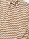 The Brown/White Cotton Stripe Square Pocket Shirt is shown from a rear perspective, laid flat against a plain white background. The shirt features a vertical brown and ecru stripe pattern, a straight hem, and a back yoke with a central box pleat.