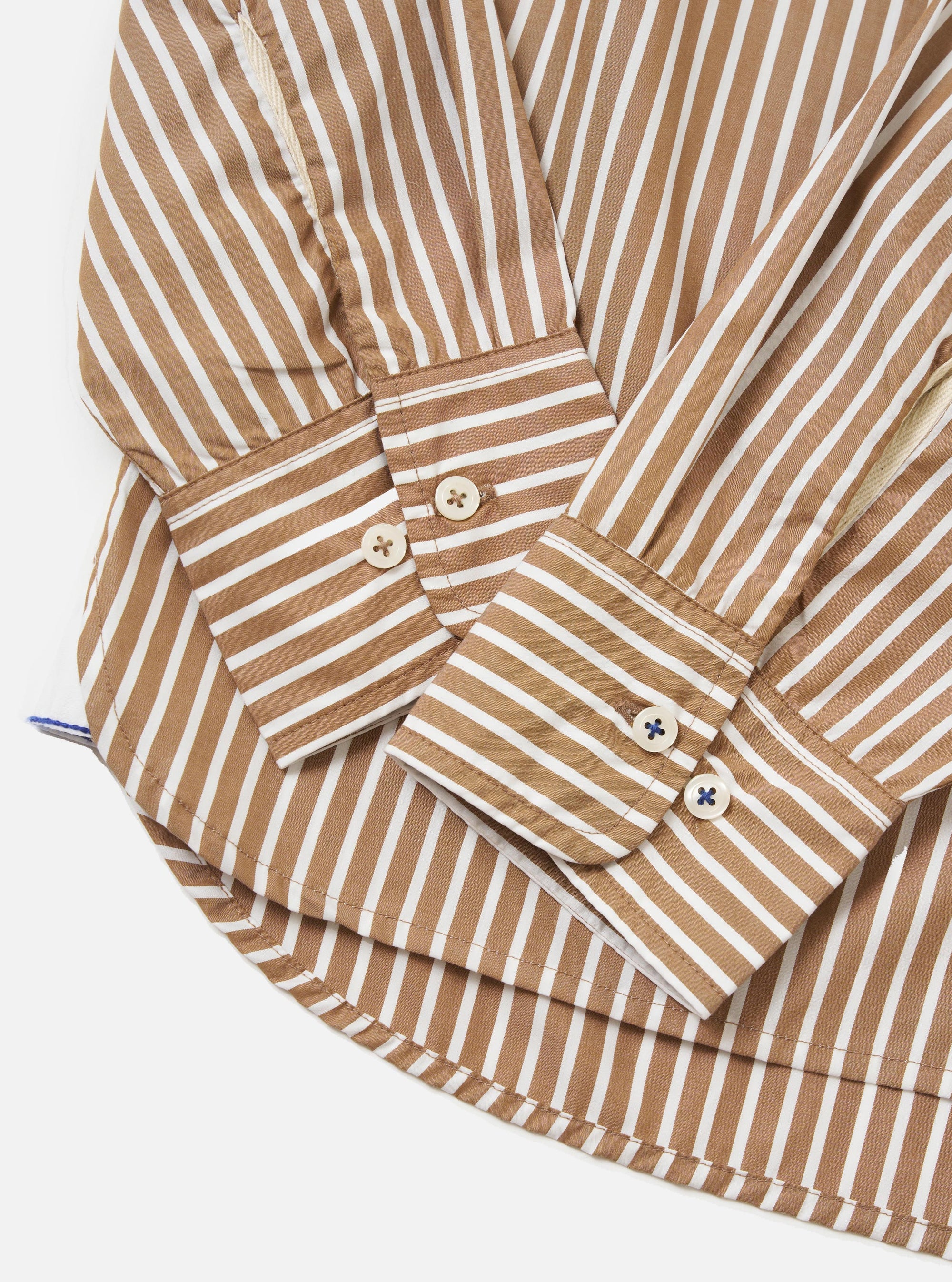 The back of the Brown/White Cotton Stripe Square Pocket Shirt is shown laid flat against a solid white background. The image highlights the vertical brown and white stripes, a horizontal back yoke, and a central box pleat designed for a relaxed fit.