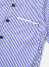 The Blue/White Cotton Stripe Z Tech Overshirt is shown from the back, displayed flat against a plain white background. The image highlights the horizontal back yoke with a central box pleat, short sleeves, and a straight hem. The garment features a thin blue and white vertical stripe pattern throughout.
