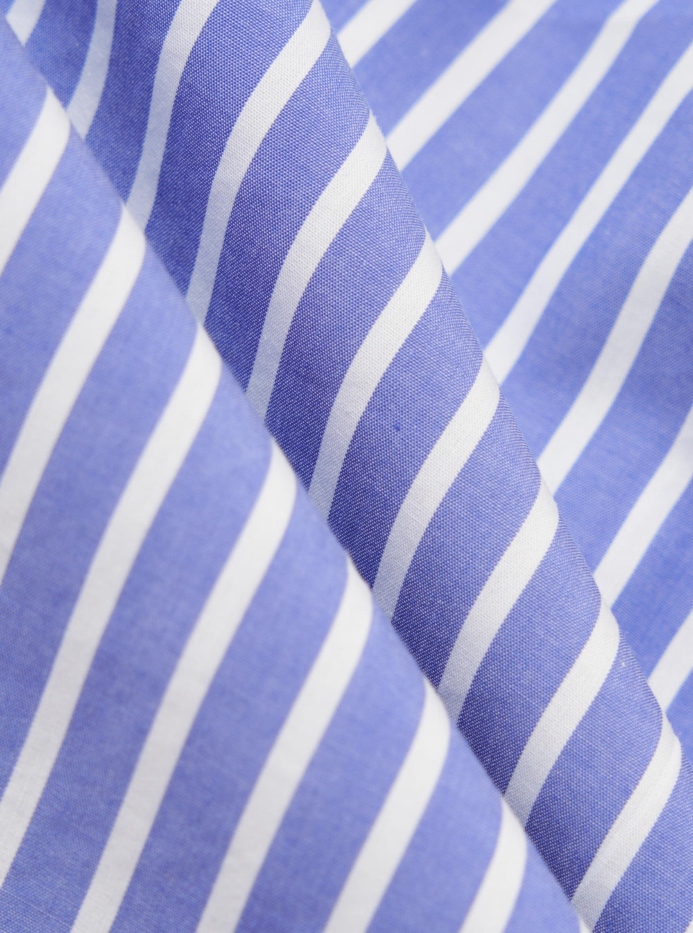 A close-up fabric swatch of the Blue/White Cotton Stripe Z Tech Overshirt displays a detailed view of the blue and white vertical stripe pattern. The image focuses on the texture and weave of the cotton fabric.
