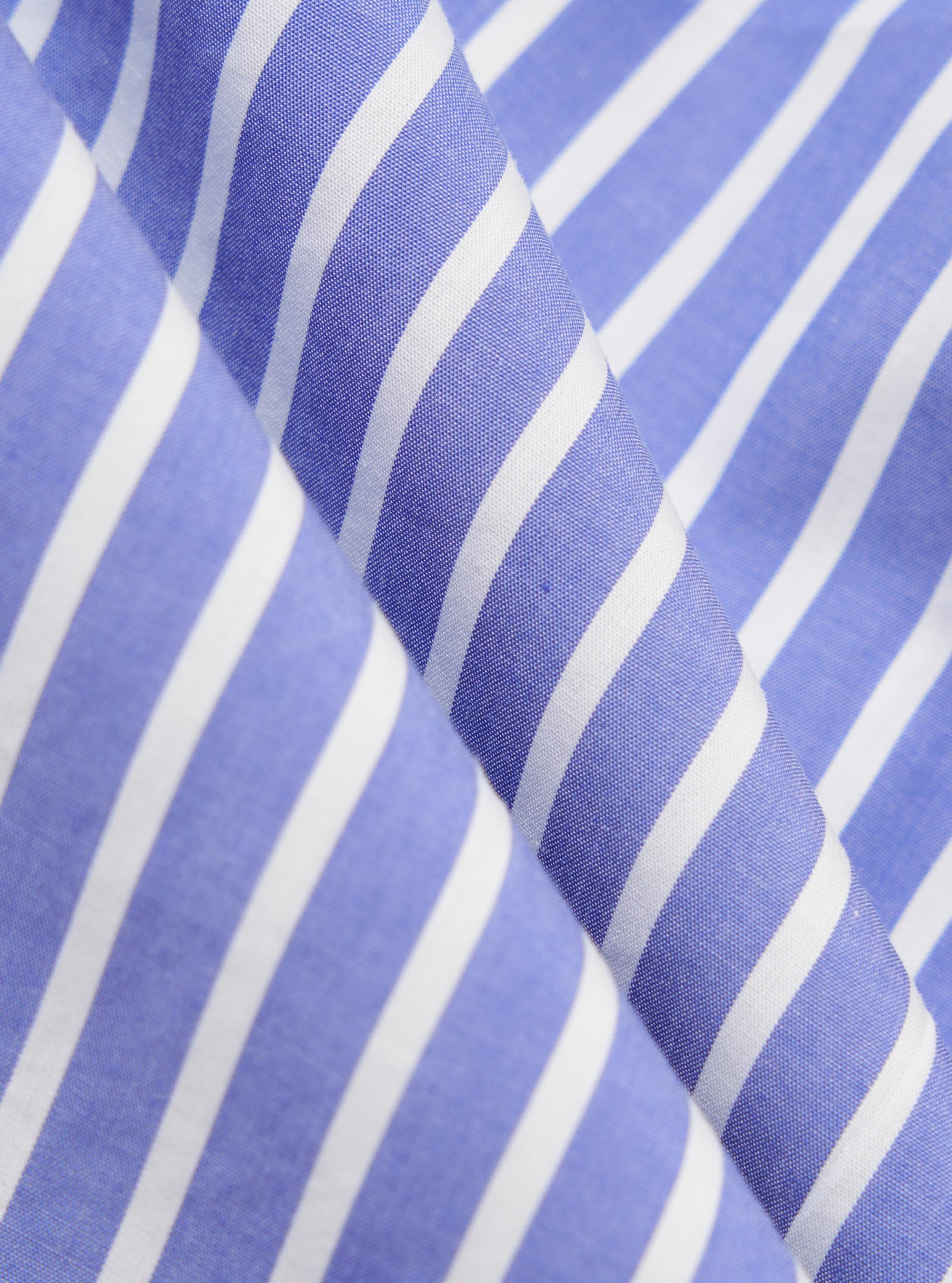 A close-up fabric swatch of the Blue/White Cotton Stripe Z Tech Overshirt displays a detailed view of the blue and white vertical stripe pattern. The image focuses on the texture and weave of the cotton fabric.