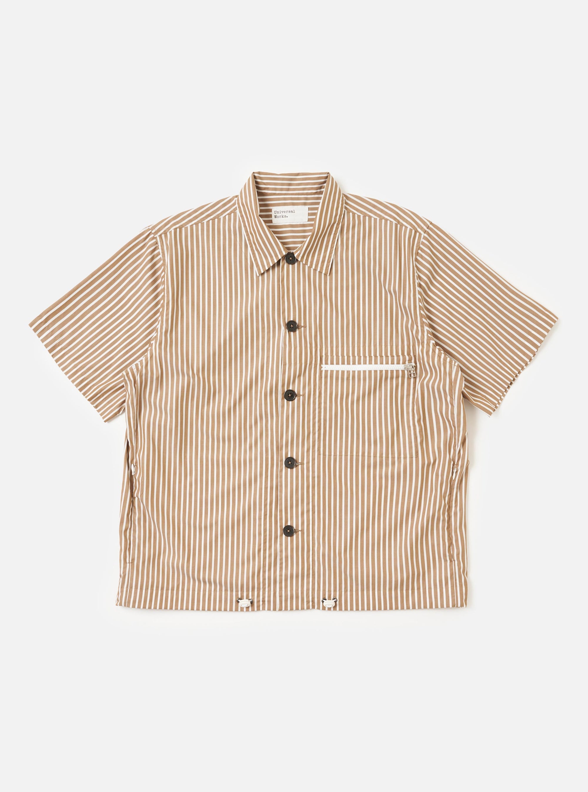 A Brown/White Cotton Stripe Z Tech Overshirt is shown laid flat against a plain white background. The garment features vertical brown and white stripes, a classic pointed collar, a full button-down front, and a vertical zip pocket on the chest.