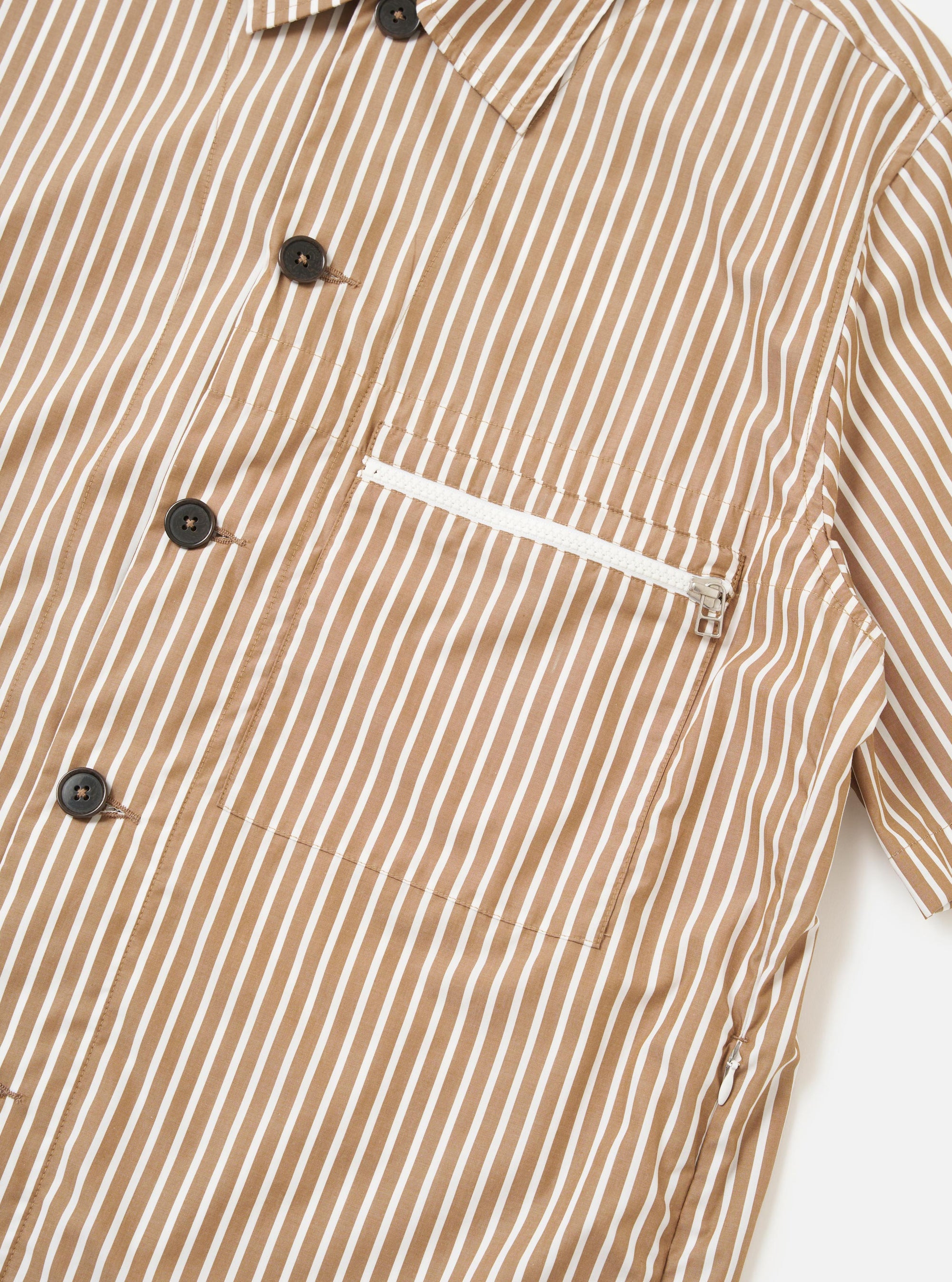 The Brown/White Cotton Stripe Z Tech Overshirt is shown from the back, laid flat against a plain white background. The garment features a vertical brown and white stripe pattern, a straight hem, and a simple collar.