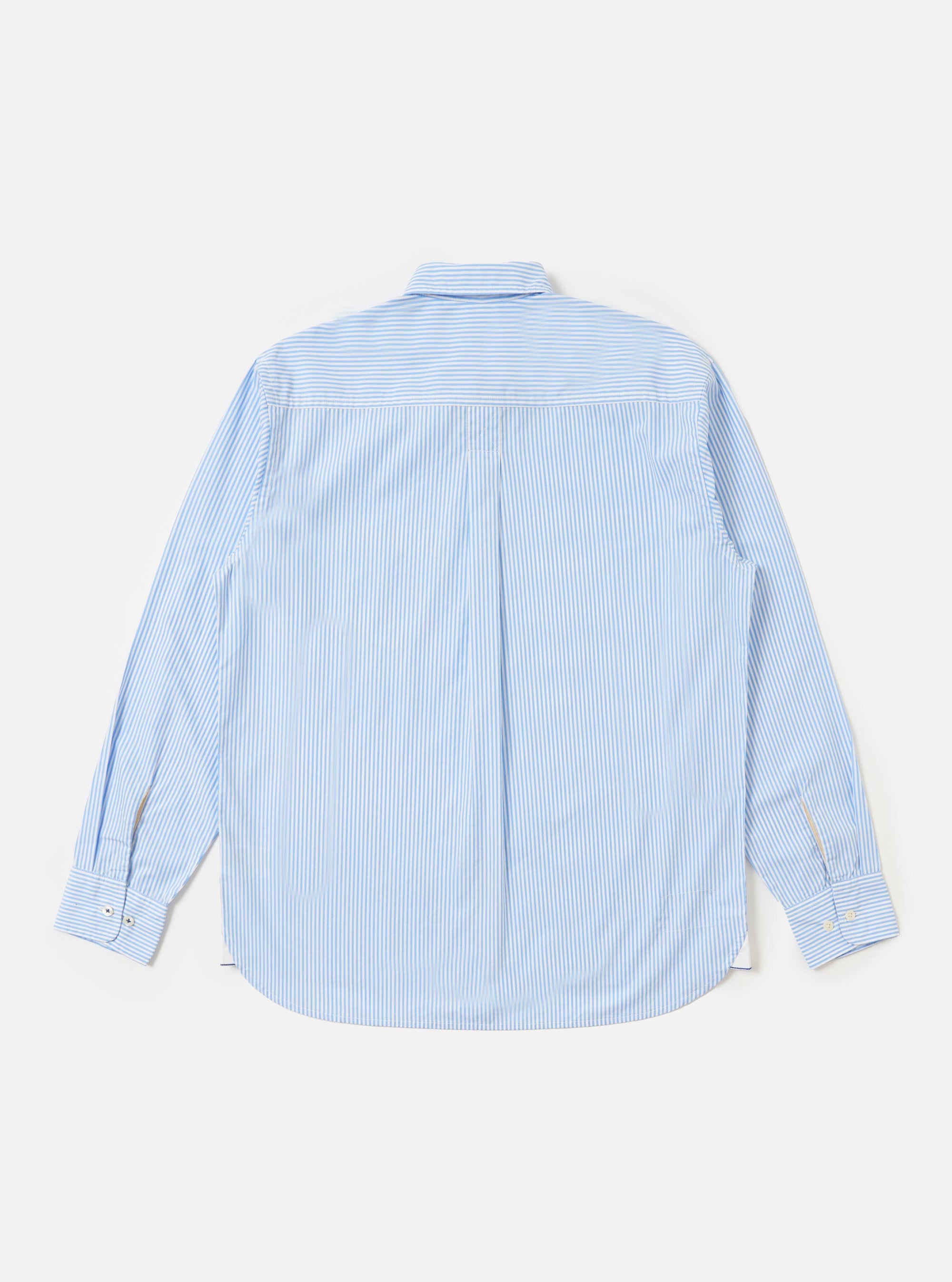 The back of the Sky/White Classic Nipon Stripe Lazy Day Shirt is displayed flat against a plain white background. The image highlights the horizontal back yoke and a central box pleat, showcasing the shirt's relaxed construction and the fine sky blue and white vertical stripes.