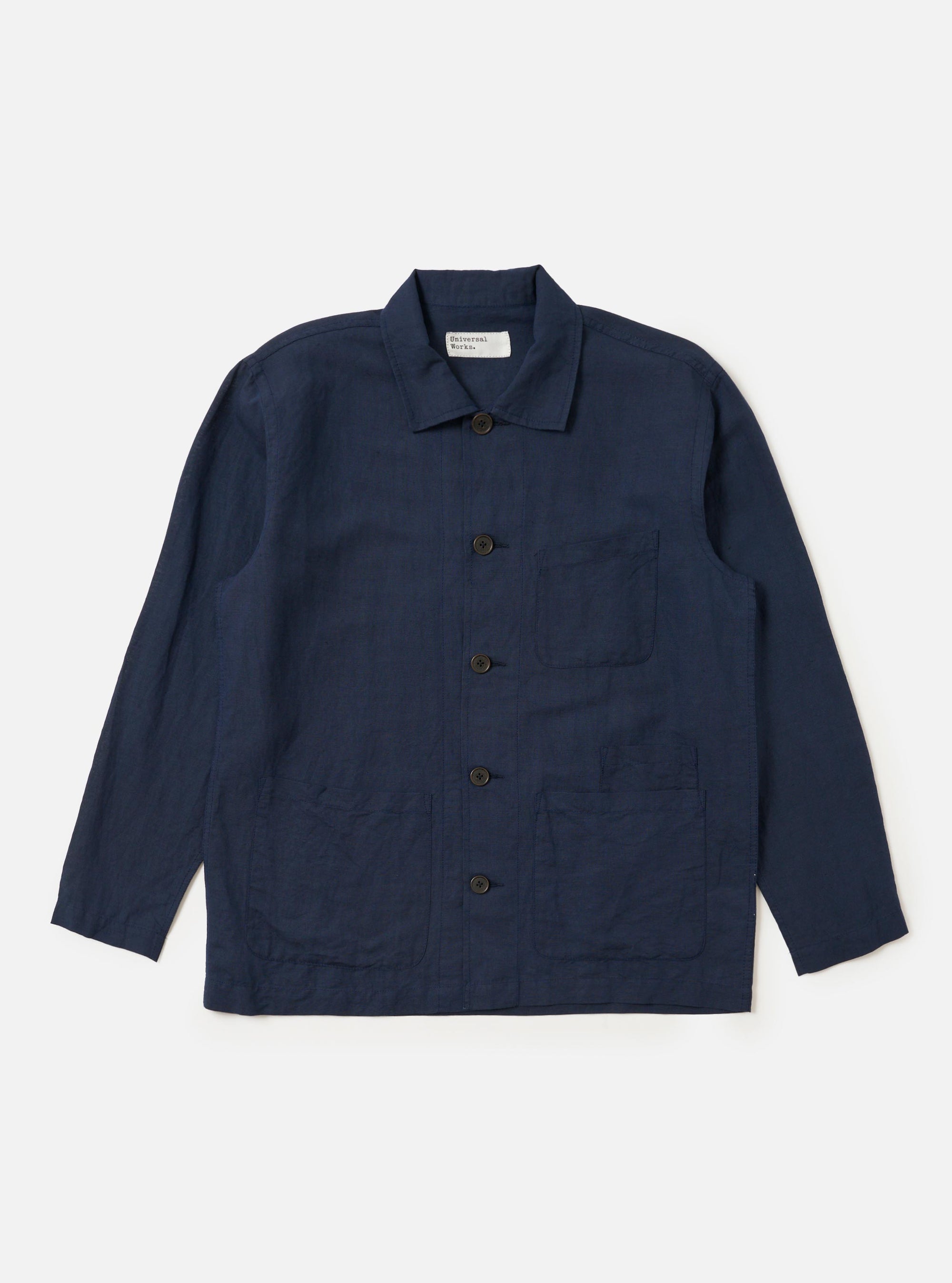 The Navy Linen Cotton Shirting Bakers Overshirt is displayed flat against a plain white background. The garment features a classic collar, a full button-down front, and three prominent patch pockets on the torso. The fabric has a visible textured linen-cotton weave in a deep navy blue color.