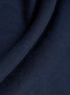A detailed, close-up fabric swatch of the Navy Linen Cotton Shirting Bakers Overshirt displays a dark navy blue textile with a visible, textured weave pattern. The fabric is shown flat and fills the frame.